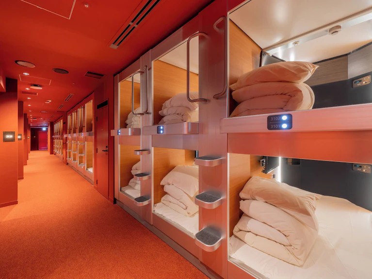 Narrow interior corridor lined with stacked compact sleeping berths