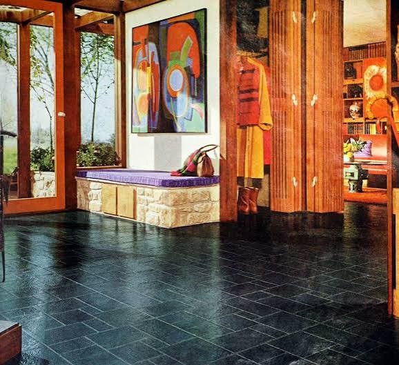 Stair hall of an early twentieth-century mansion with patterned tiled flooring