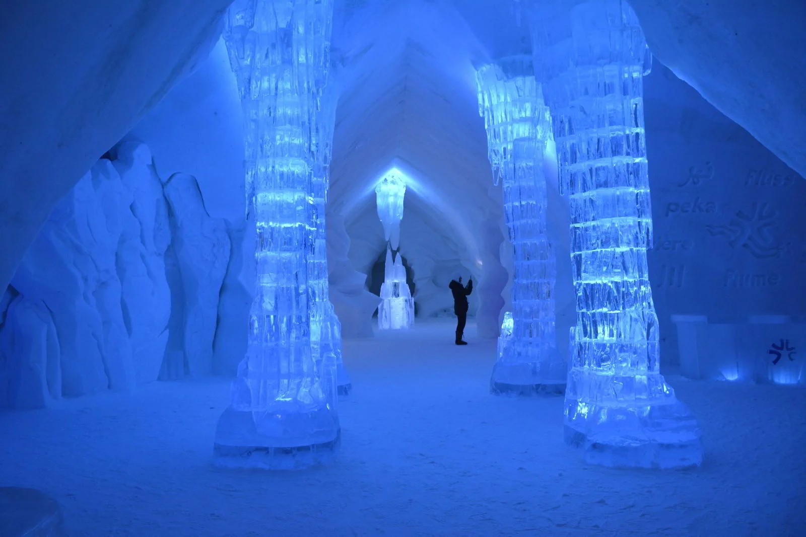 Carved chamber of ice and packed snow with a low bed platform under a vaulted roof